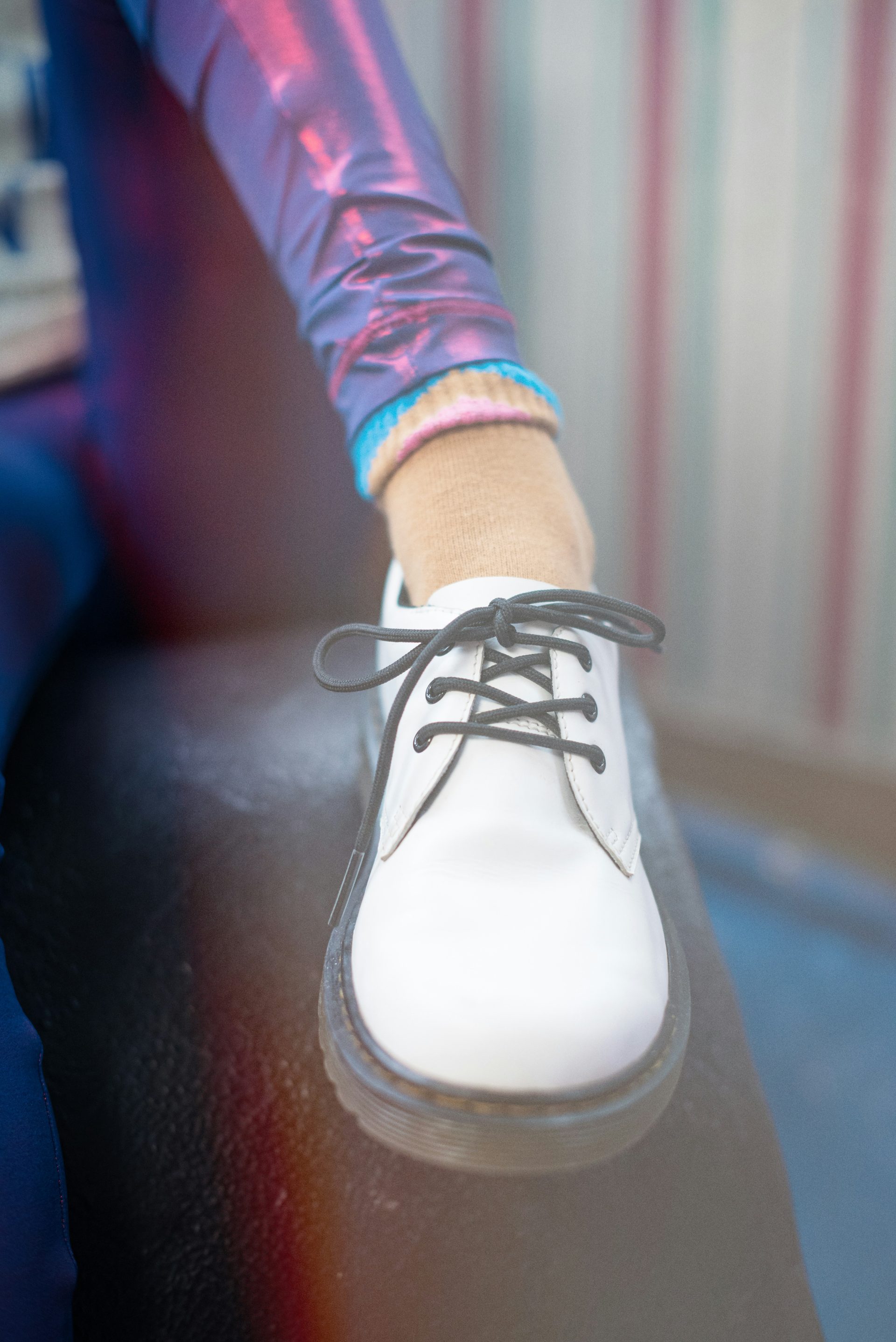 A woman's foot with a white shoe on it