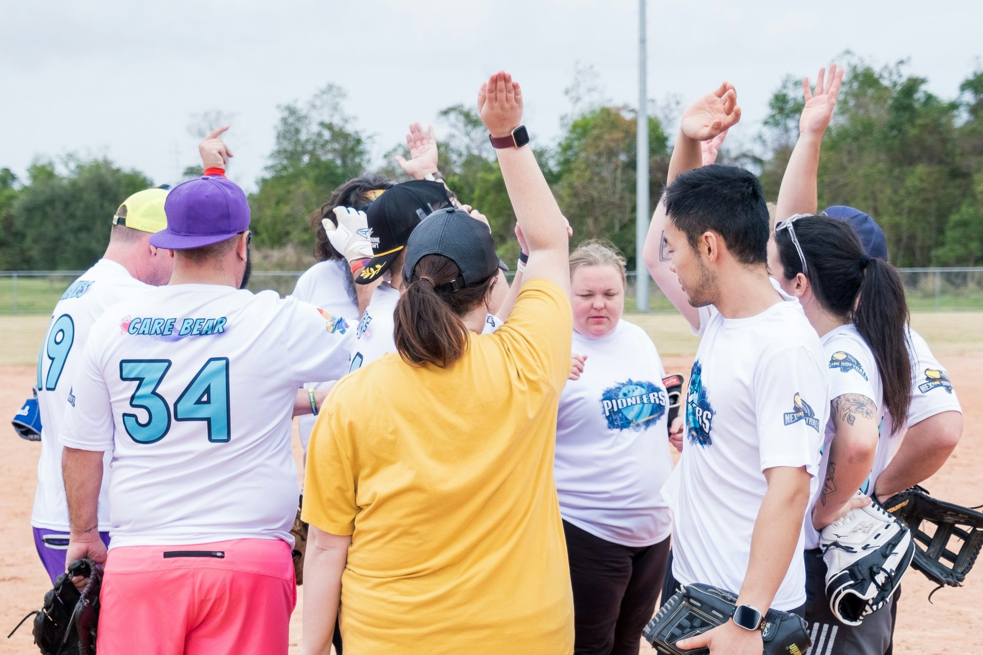 A group of people standing on top of a baseball field